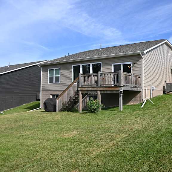 a house with a deck and a garage.