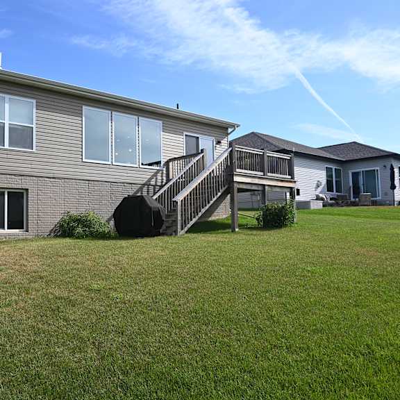 a house with a grey siding and a black staircase.