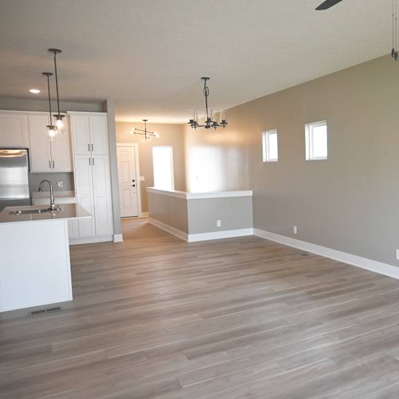 a large empty room with wooden floors and white walls.