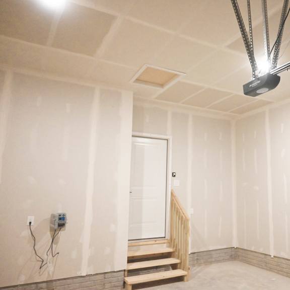a room with a staircase and a light hanging from the ceiling.