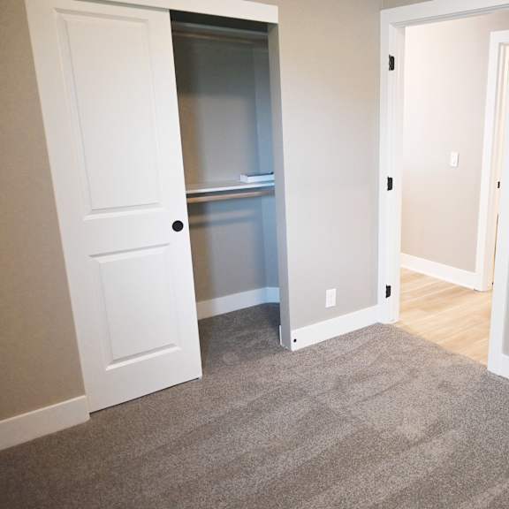 a room with a white door and a carpeted floor.