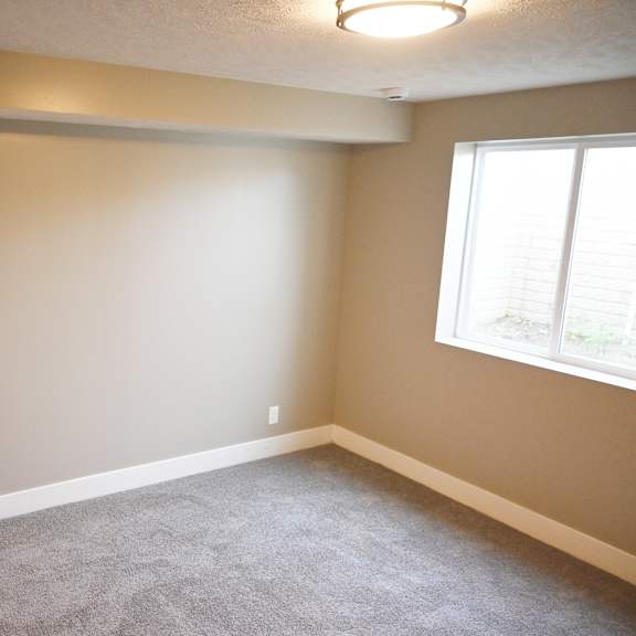 a room with a white door and a window with blinds.