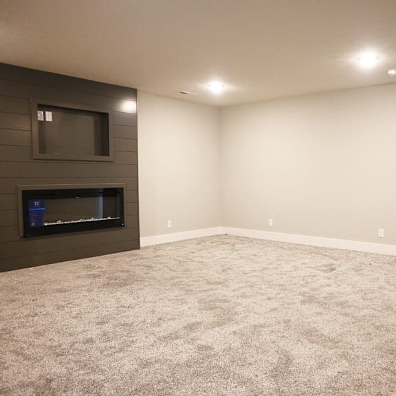a living room with a fireplace and a flat screen tv.