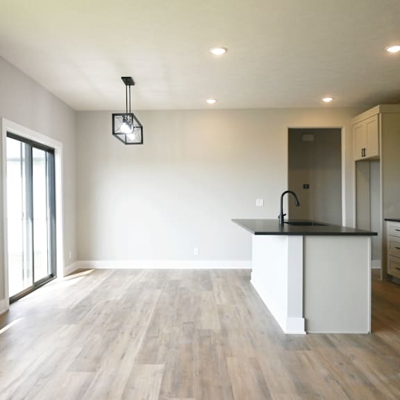 a kitchen with a black countertop and white cabinets.