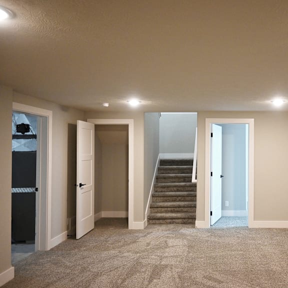 a room with a staircase leading to the second floor.