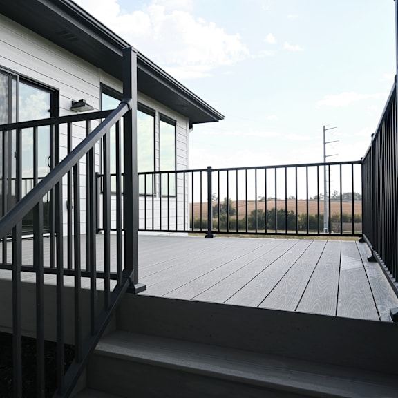 a black metal railing on a wooden deck.