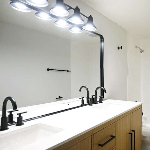 a bathroom with a white counter top and a white sink.