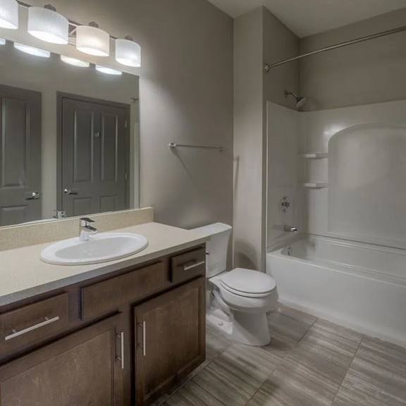 a bathroom with a sink, toilet, and bathtub.