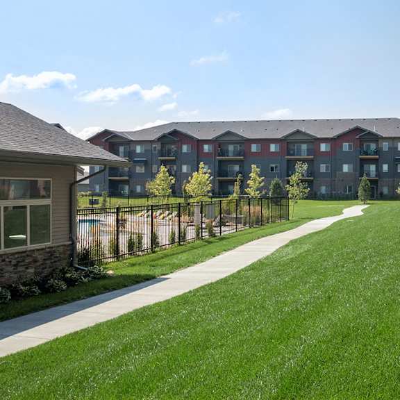 a grassy area in front of apartment buildings.