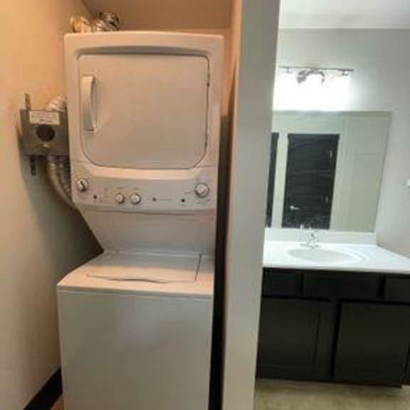 a white tankless water heater in a bathroom.