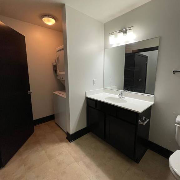 a bathroom with a sink, mirror, and toilet.