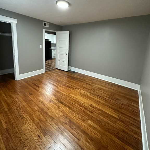 a room with wooden flooring and a white ceiling.