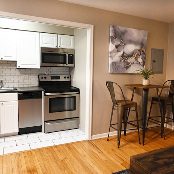 a kitchen with a dining table and chairs.