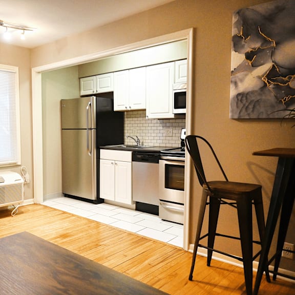a kitchen with a refrigerator, oven, and microwave.