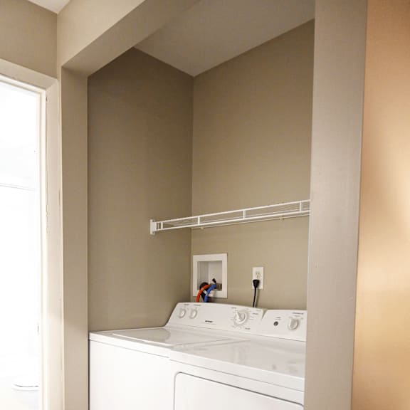 a white washing machine and dryer in a laundry room.