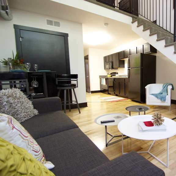 a living room with a grey couch and a white coffee table.