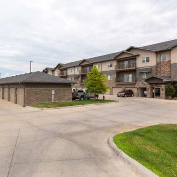 a long driveway leads to apartment buildings.