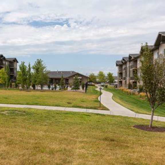 a grassy area in front of apartment buildings.