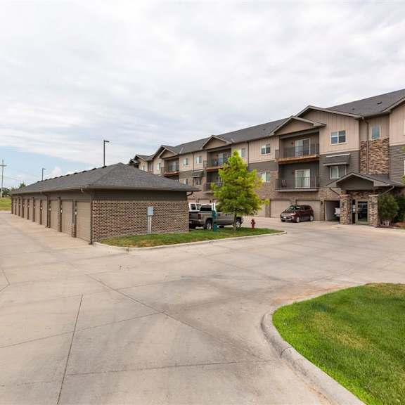 a long driveway leads to apartment buildings.