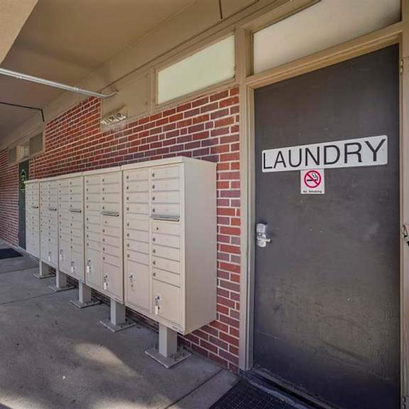 a laundry sign is on a door with a no smoking sign above it.