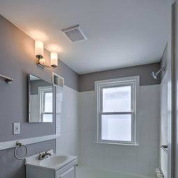a small bathroom with a toilet, sink, and bathtub.