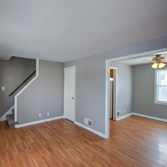 a room with wooden floors and a staircase.