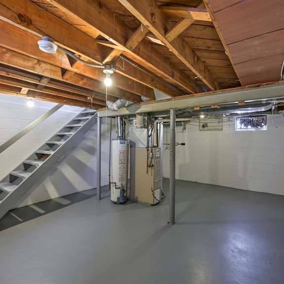 a room with a staircase and a white wall.