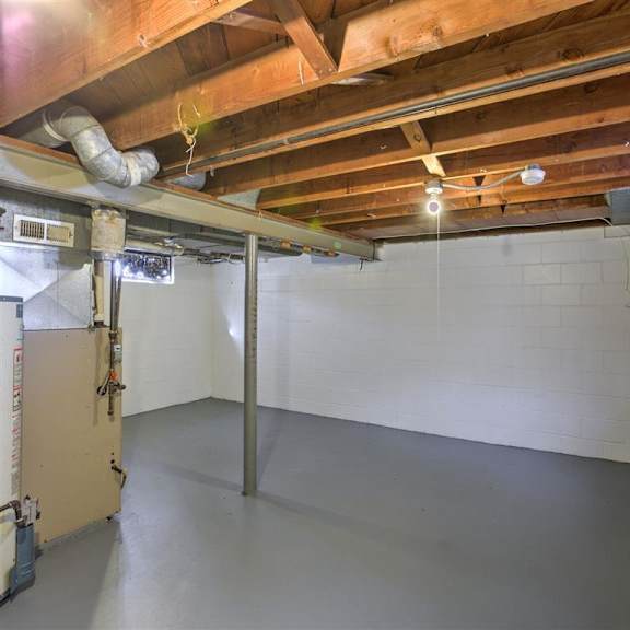 a room with a white tile wall and a wooden ceiling.