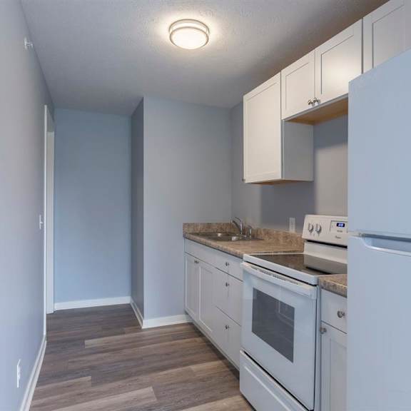 a kitchen with white appliances and cabinets.