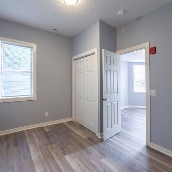 a room with a white door and a window with blinds.