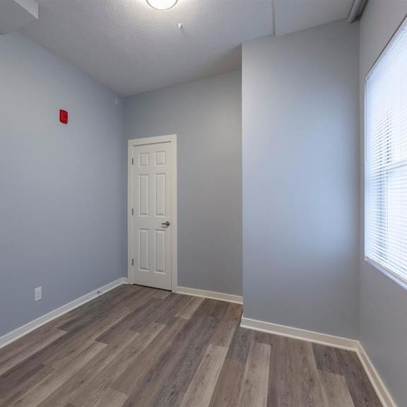 a room with a wooden floor and a white door.
