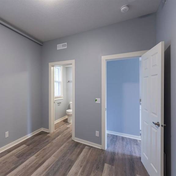 a room with a toilet and a door.