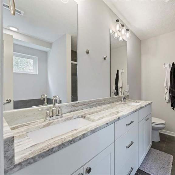 a bathroom with a marble countertop and a towel hanging on the wall.
