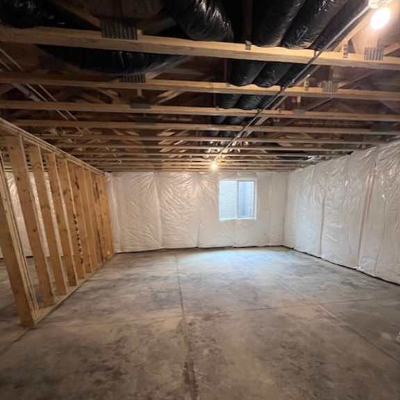 a room under construction with wooden framing and insulation on the walls.