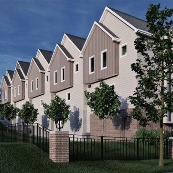 a row of houses with a black fence in front.