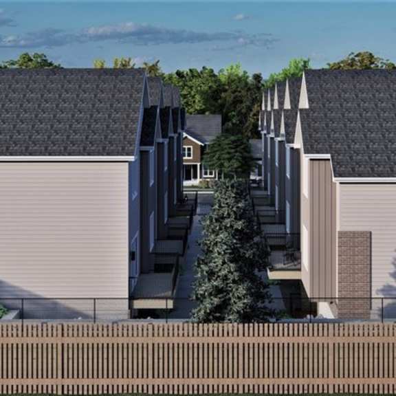 a modern house with a grey roof and a brown fence.