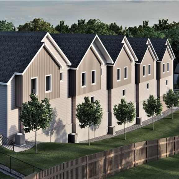 a row of houses with a fence in front.