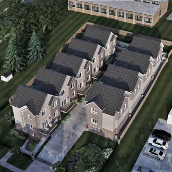 a rendering of a building complex with multiple buildings and a parking lot.
