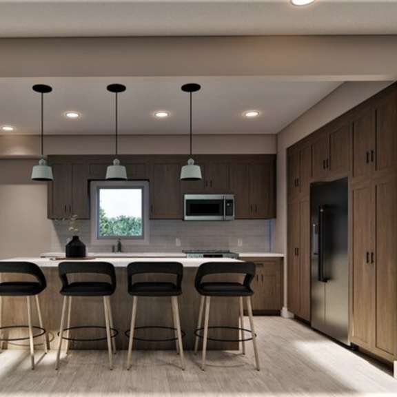 a modern kitchen with a bar area and a staircase.