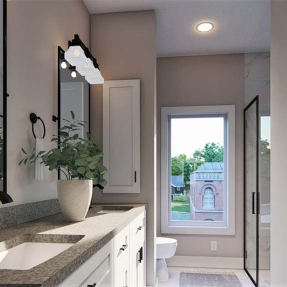 a bathroom with a sink, mirror, and a potted plant.