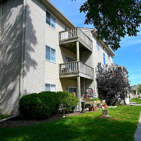 a sunny day at a residential apartment complex with a clear blue sky.