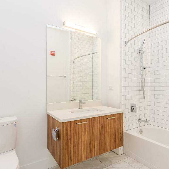 a white bathroom with a toilet sink and shower