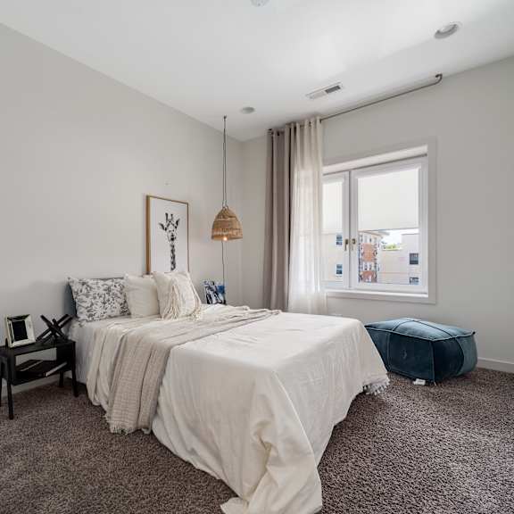 a bedroom with a large bed and a window.