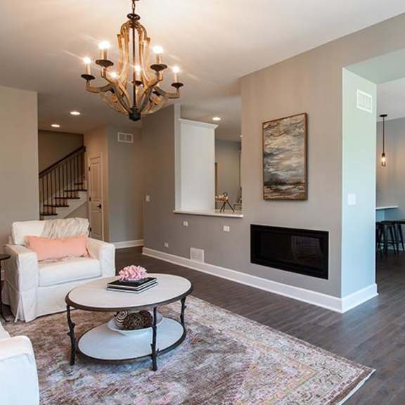 a living room with a fireplace and a table at countryside townhomes, countryside, 60525