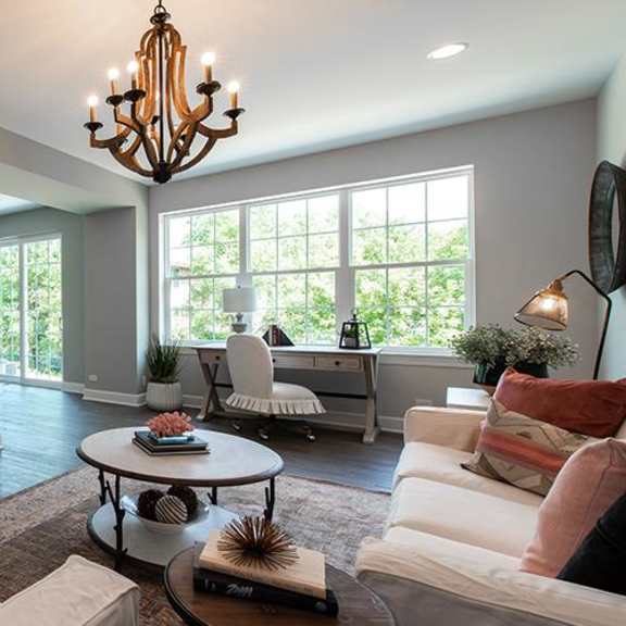 a living room with a couch and a table at countryside townhomes, countryside, il 60525
