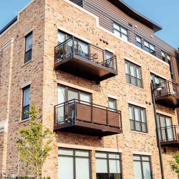 a brick apartment building with balconies at barrington 101, barrington illinois