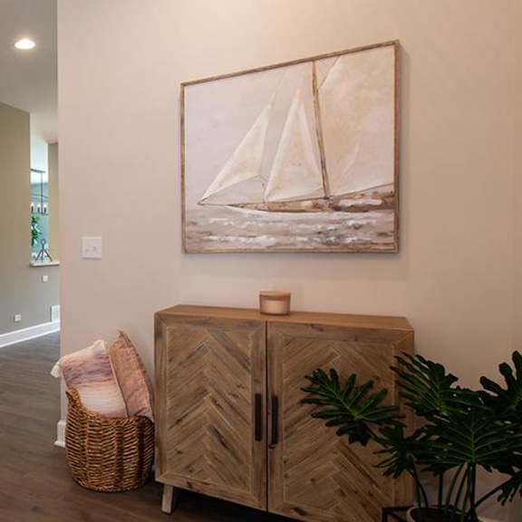 a living room with a staircase and a painting on the wall at countryside townhomes, illinois, 60525