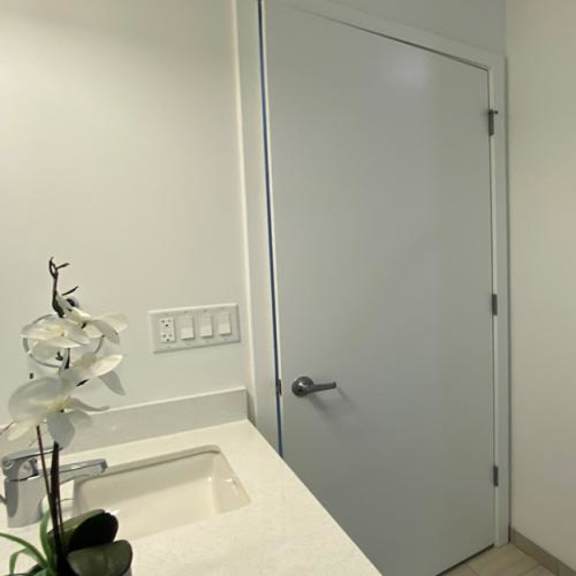 a white bathroom with a shower and a sink at highwood 546, highwood