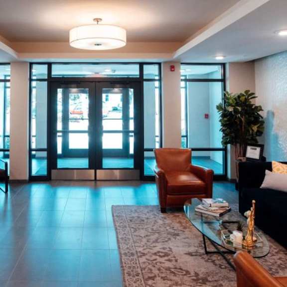 a lobby with a couch and chairs and a table at barrington 101, barrington, il