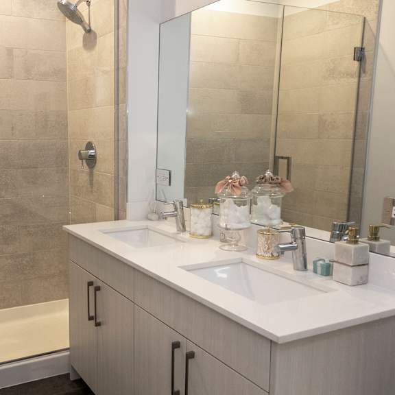 a bathroom with a shower and a sink and a mirror